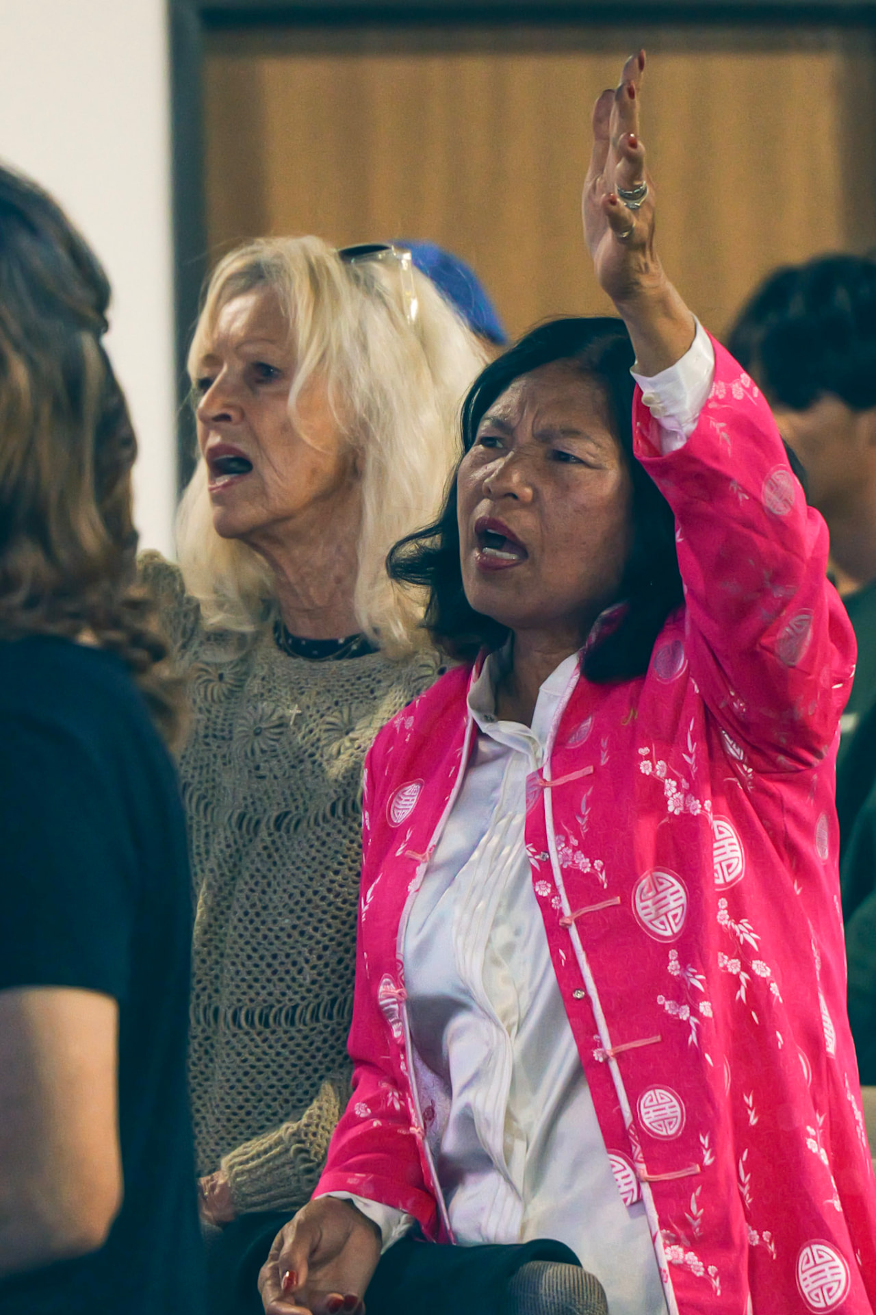Women worshiping with hands raised