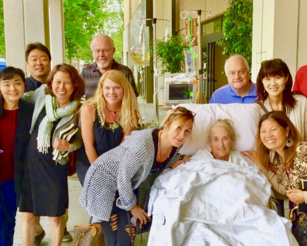 Church members visiting and praying with a friend